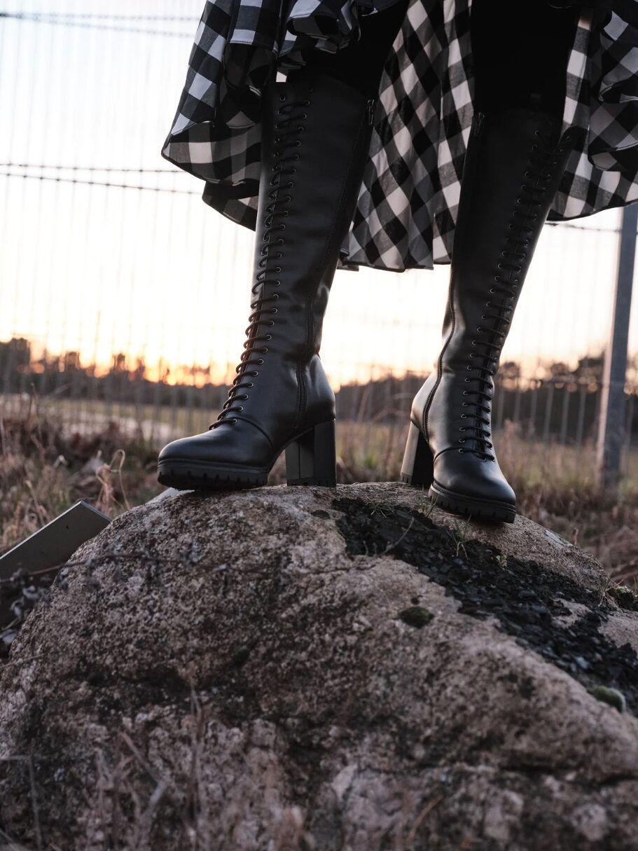 A model wearing sustainable boots from Bhava
