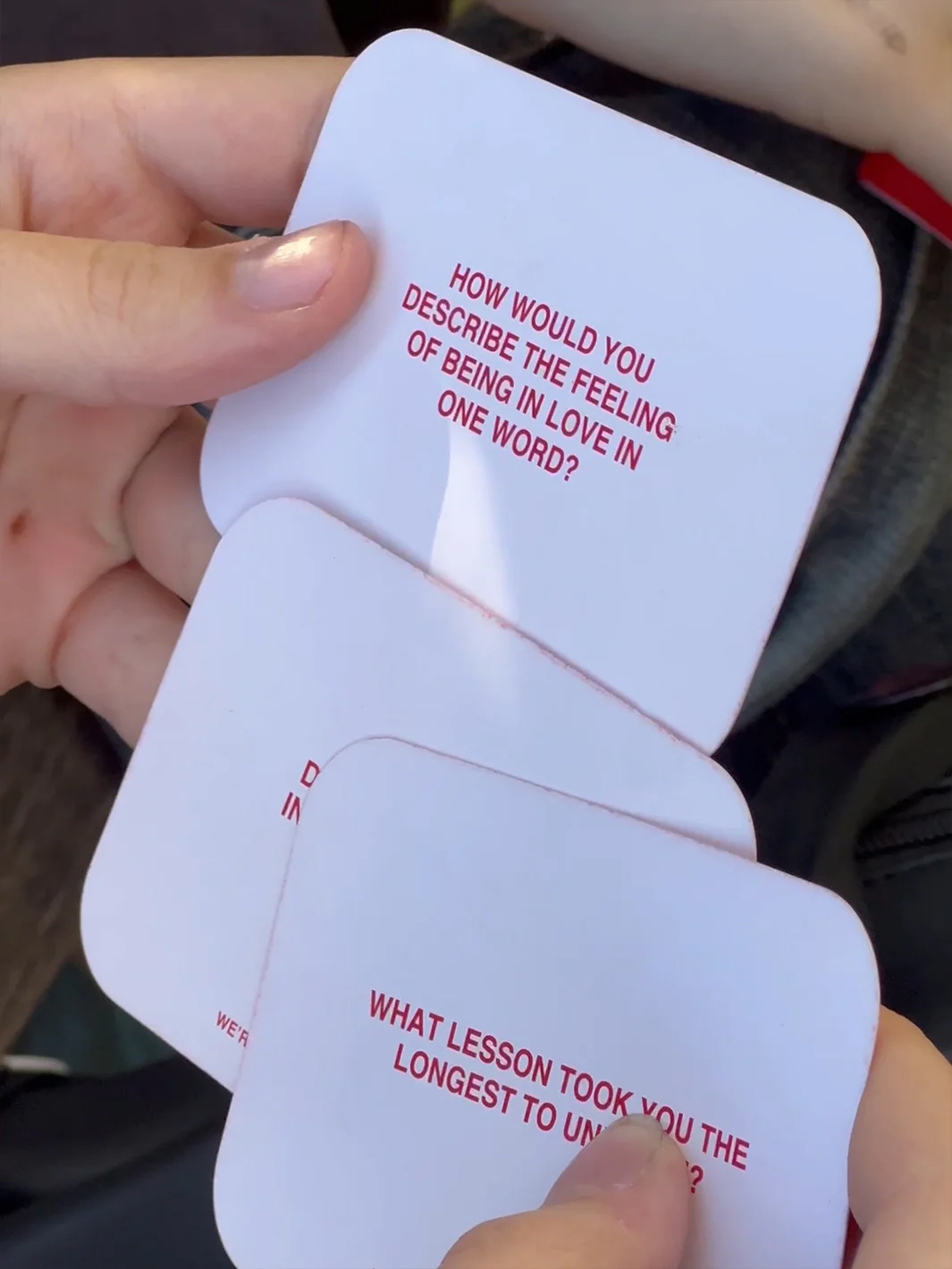A pair of people holding up cards that say how you feel about someone.