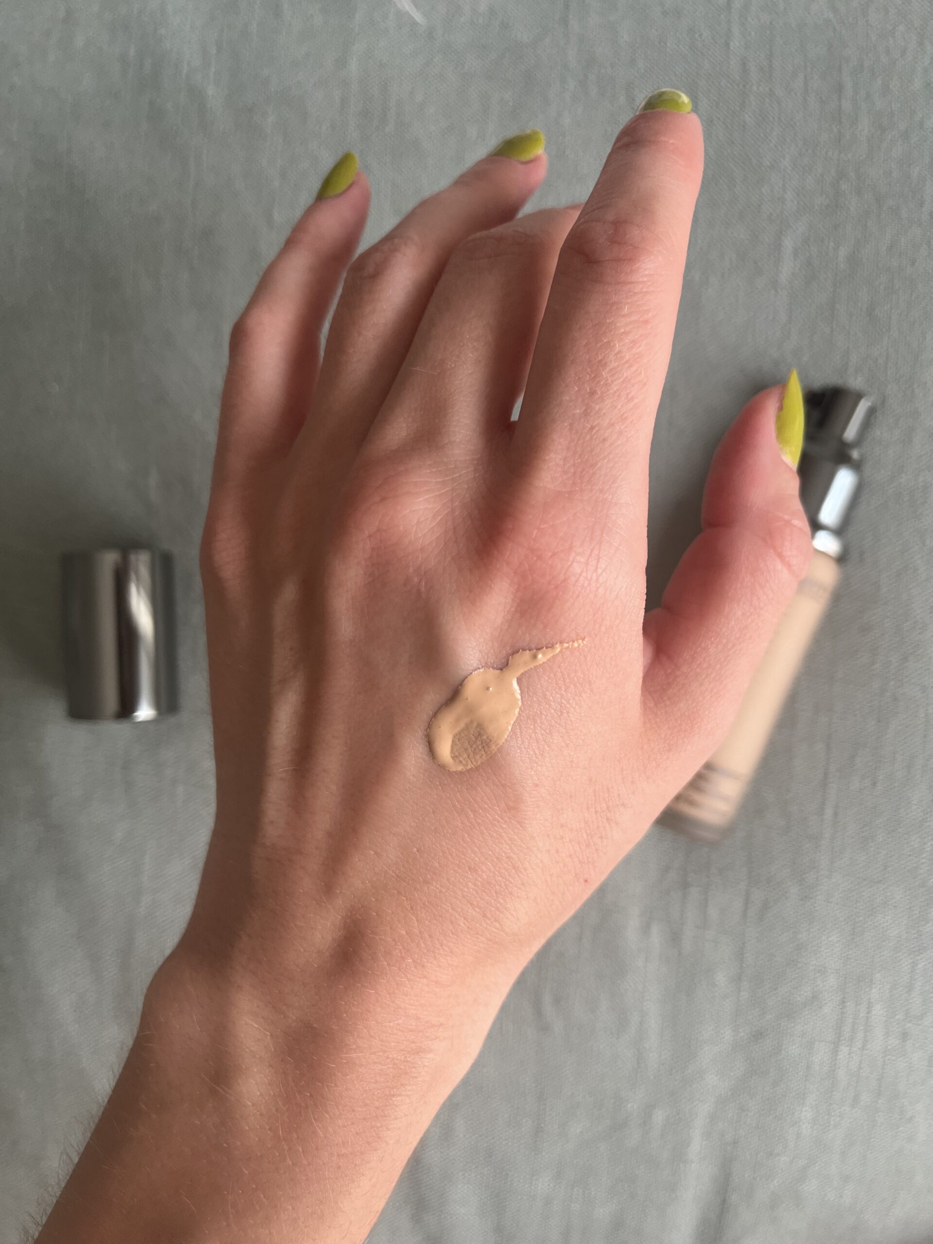 A sample of Juice Beauty foundation on the back of a hand.