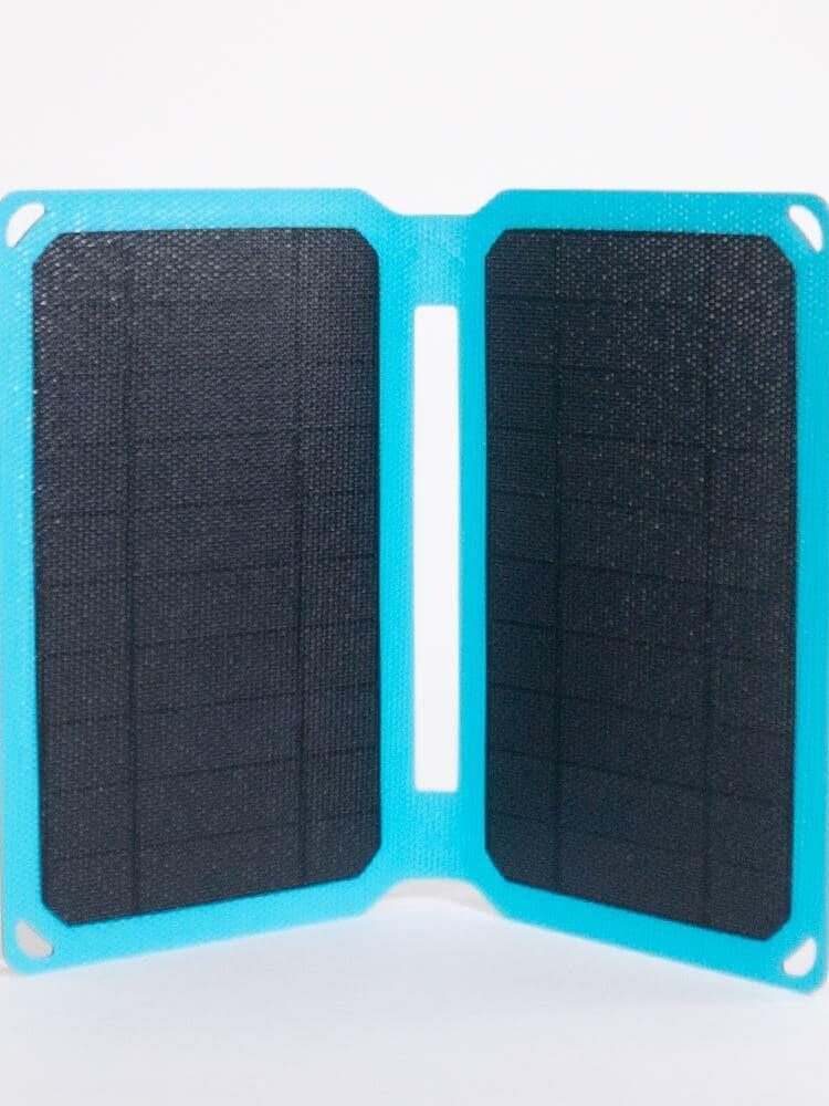 A compact, foldable solar panel with a blue frame standing upright on a white background.