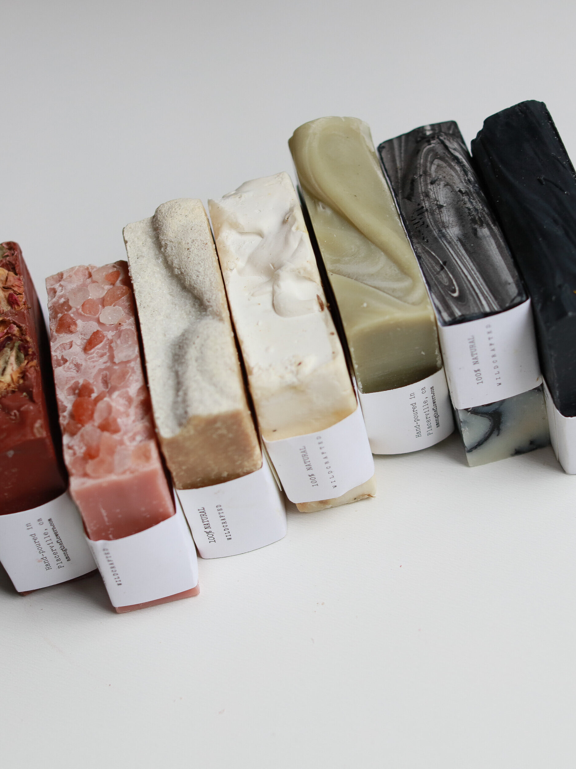 Among the Flowers soap bars stacked next to one another.