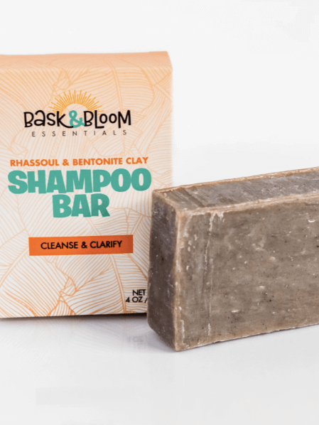 A shampoo bar from Bask & Bloom next to it's packaging. 