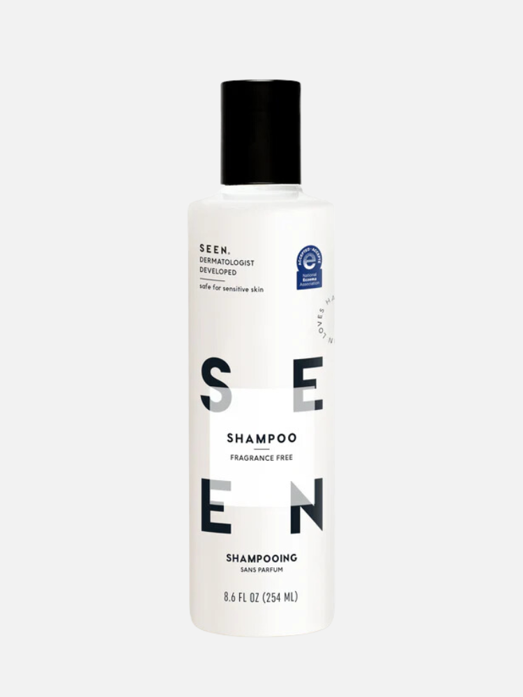 A white bottle of SEEN Fragrance Free Shampoo with black text. It is 8.6 fl oz.