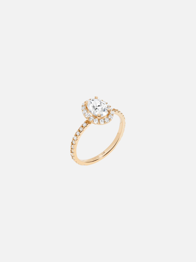 A gold engagement ring with a central oval diamond surrounded by smaller diamonds, set on a diamond-studded band.