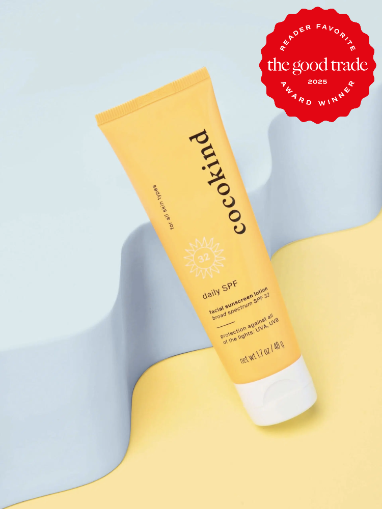 Tube of Cocokind Daily SPF 32 sunscreen on a blue and yellow background with a "The Good Trade 2025" award badge.